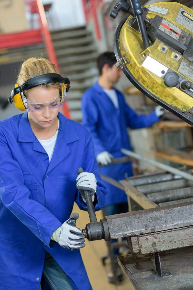 Female industrial worker wearing noise isolating hearing protection