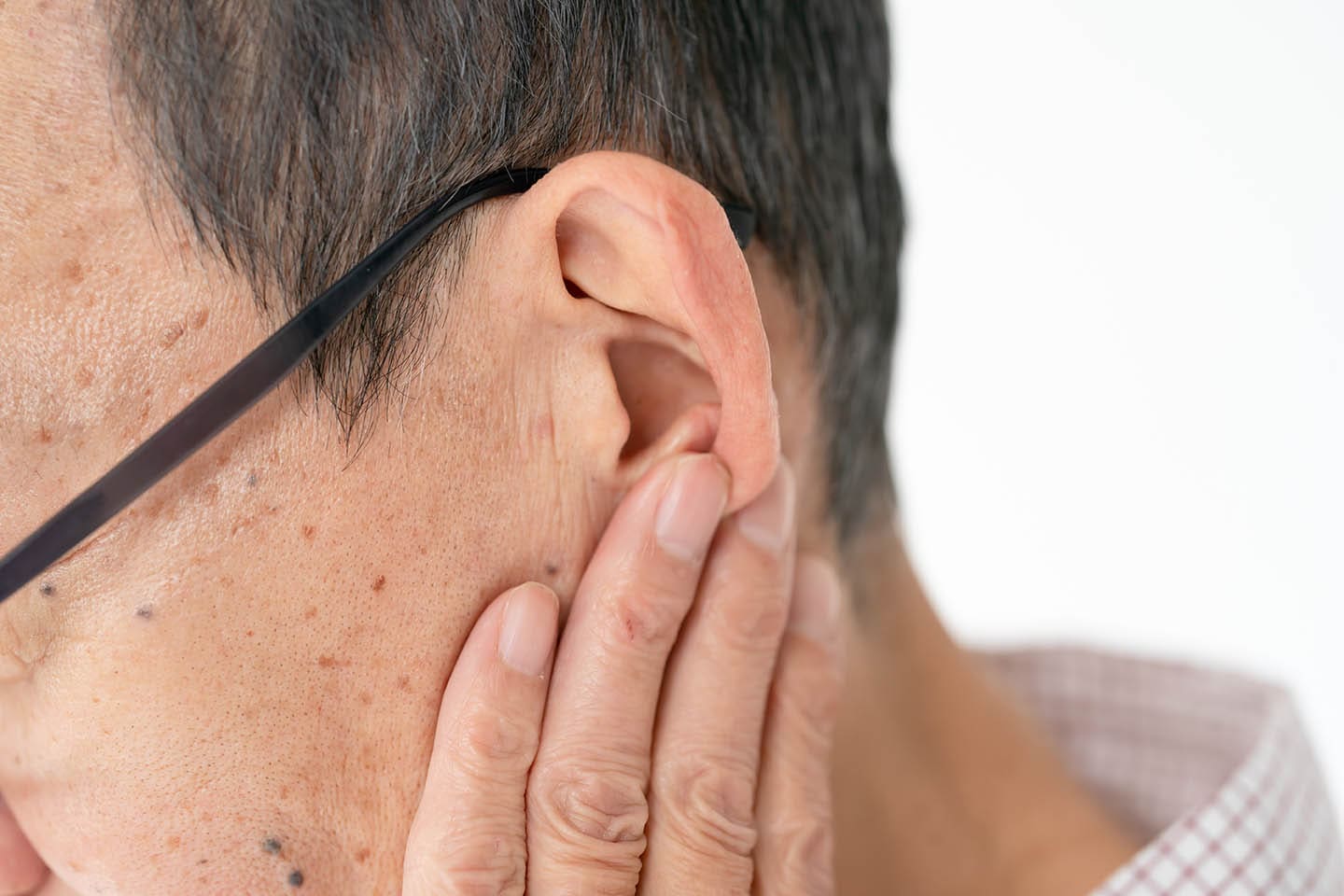 Man with earwax pain touching his ears